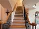 Beautiful staircase with wood and wrought iron bannister provides access to upper levels of the home at 2123 Floral Ridge Dr, Dacula, GA 30019