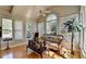 Bright sunroom with hardwood floors, a ceiling fan, and lots of windows provides ample sunlight at 2123 Floral Ridge Dr, Dacula, GA 30019