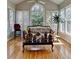 Bright sunroom with hardwood floors, lots of windows, and an arched window at 2123 Floral Ridge Dr, Dacula, GA 30019