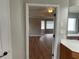 View from the bathroom highlighting hardwood floors and abundant natural light into the bedroom at 2123 Floral Ridge Dr, Dacula, GA 30019