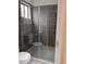 Bathroom with walk in glass shower with gray tile at 2645 Trotters Walk Trl, Snellville, GA 30078