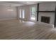 Spacious living room featuring a stone fireplace, modern lighting and light wood flooring at 2645 Trotters Walk Trl, Snellville, GA 30078