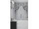 Bathroom featuring modern fixtures, a soaking tub, and statement marble paneling at 654 Longleaf Dr, Atlanta, GA 30342