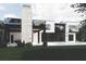 Modern home showcasing stunning architecture, a stone chimney, an outdoor terrace, and a pristine pool at 654 Longleaf Dr, Atlanta, GA 30342