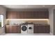 Functional laundry room with front-load machines and lots of storage at 654 Longleaf Dr, Atlanta, GA 30342
