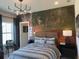 Stylized bedroom with unique mural wall and modern lighting fixture at 750 Keystone Dr, Woodstock, GA 30188