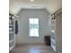 Spacious walk-in closet with custom shelving and view to the neighborhood at 750 Keystone Dr, Woodstock, GA 30188