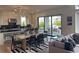 Open dining room with decorative pendant lights and sliding glass door to backyard at 750 Keystone Dr, Woodstock, GA 30188