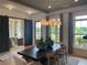 Stylish dining room with table, chairs, sliding barn door, and view of front yard at 750 Keystone Dr, Woodstock, GA 30188
