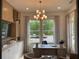 Sunlit home office with built-in shelving, modern light fixture and views of nature at 750 Keystone Dr, Woodstock, GA 30188