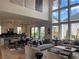 Open concept living and kitchen area with high ceilings and large windows creating a light-filled and airy space at 750 Keystone Dr, Woodstock, GA 30188