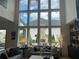 Inviting living room with soaring windows, a stone fireplace, and stylish decor for a cozy and sophisticated atmosphere at 750 Keystone Dr, Woodstock, GA 30188
