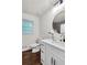 Newly renovated bathroom features a modern vanity, sleek fixtures, and stylish round mirror at 3420 Burnt Hickory Nw Rd, Marietta, GA 30064