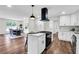 Modern kitchen features a large island with cooktop and opens to dining area at 3420 Burnt Hickory Nw Rd, Marietta, GA 30064