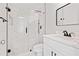 Modern bathroom featuring a glass-enclosed shower with marble tile and sleek fixtures at 5950 Milligan Ct, Atlanta, GA 30349
