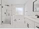 Bright bathroom with double vanity, glass shower, and separate soaking tub with modern fixtures at 5950 Milligan Ct, Atlanta, GA 30349
