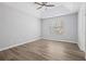 Neutral bedroom with hardwood floors, tray ceiling, and a window offering natural light at 5950 Milligan Ct, Atlanta, GA 30349