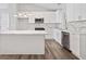 Bright kitchen features white cabinetry, stainless steel appliances, an island and marble countertops at 5950 Milligan Ct, Atlanta, GA 30349