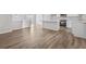 Open kitchen and living space featuring hardwood floors and an island with a marble countertop at 5950 Milligan Ct, Atlanta, GA 30349