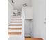 Bright staircase featuring hardwood stairs and white risers leading to a kitchen area at 5950 Milligan Ct, Atlanta, GA 30349