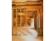 Unfinished basement featuring framed walls, exposed insulation and a door to the exterior for natural light at 6175 Beaver Crossing Dr, Cumming, GA 30040