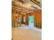 Unfinished basement featuring framed walls, exposed insulation and a door to the exterior for natural light at 6175 Beaver Crossing Dr, Cumming, GA 30040