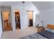 This bedroom features carpeted floors, white walls, a ceiling fan, and an ensuite bathroom and closet at 6175 Beaver Crossing Dr, Cumming, GA 30040