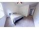 This cozy bedroom features vaulted ceilings, a ceiling fan, carpeted floors, and a large window at 6175 Beaver Crossing Dr, Cumming, GA 30040