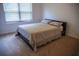 Bright, carpeted bedroom featuring a large window and a bed at 6175 Beaver Crossing Dr, Cumming, GA 30040