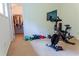 Workout room with a Peloton bike, free weights and a view into a walk-in closet at 6175 Beaver Crossing Dr, Cumming, GA 30040
