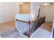Upstairs hallway with carpet floors, fresh white paint, and wood and iron railing at 6175 Beaver Crossing Dr, Cumming, GA 30040