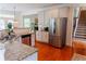 Spacious kitchen with stainless steel appliances, granite countertops, and hardwood flooring at 6175 Beaver Crossing Dr, Cumming, GA 30040