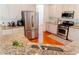 Modern kitchen featuring stainless steel appliances, granite countertops, and ample cabinet space at 6175 Beaver Crossing Dr, Cumming, GA 30040