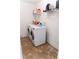 Laundry room with washer, dryer, overhead shelving, and a drying rack at 6175 Beaver Crossing Dr, Cumming, GA 30040