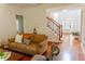 Cozy living room with a comfortable sofa, staircase access, and an abundance of natural light at 6175 Beaver Crossing Dr, Cumming, GA 30040