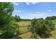 Backyard view with a secure wrought iron fence overlooking a lake and wooded horizon at 1028 Southwood Dr, Villa Rica, GA 30180