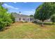 Spacious backyard and home exterior, surrounded by greenery and a neatly maintained lawn at 1028 Southwood Dr, Villa Rica, GA 30180