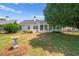 Spacious backyard featuring a well-manicured lawn, mature trees, and tasteful landscaping at 1028 Southwood Dr, Villa Rica, GA 30180