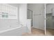 Bathroom featuring a soaking tub, glass enclosed shower, and tile floor at 1028 Southwood Dr, Villa Rica, GA 30180