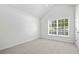 Bright bedroom featuring large window, neutral walls, and plush carpeting, creating a serene and inviting space at 1028 Southwood Dr, Villa Rica, GA 30180