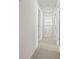 Carpeted hallway with neutral paint and white doors at 1028 Southwood Dr, Villa Rica, GA 30180