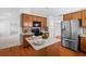 Bright kitchen with stainless steel appliances, center island, and easy access to the dining room at 1028 Southwood Dr, Villa Rica, GA 30180