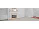 Bright living room featuring a fireplace, built-in shelves, and an entrance to foyer with hardwood flooring at 1028 Southwood Dr, Villa Rica, GA 30180