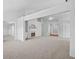 Open-concept living area with neutral colors, modern lighting, and a fireplace at 1028 Southwood Dr, Villa Rica, GA 30180