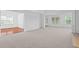 Spacious living room with neutral carpet, large windows, and adjacent dining area at 1028 Southwood Dr, Villa Rica, GA 30180