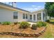 Sunroom adjacent to the patio enhanced with colorful flower beds, stone border and lush plantings at 1028 Southwood Dr, Villa Rica, GA 30180