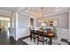 Dining room with hardwood floors, wainscoting, a stylish light fixture, and seating for six at 2905 Medford Drive, Cumming, GA 30041