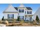 Charming two-story home with a stone foundation, black shutters, white siding, and a covered front porch at 2905 Medford Drive, Cumming, GA 30041