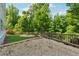 Beautiful backyard with a gravel area and fire pit, complemented by lush greenery at 3998 Commodore Dr, Atlanta, GA 30341