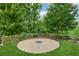 Landscaped backyard featuring a charming gravel fire pit area, perfect for outdoor entertaining at 3998 Commodore Dr, Atlanta, GA 30341